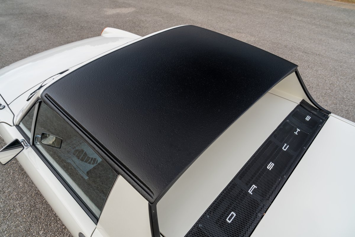 Top-down view of a white 1974 Porsche 914 Can-Am with a black targa top and black engine lid grille.