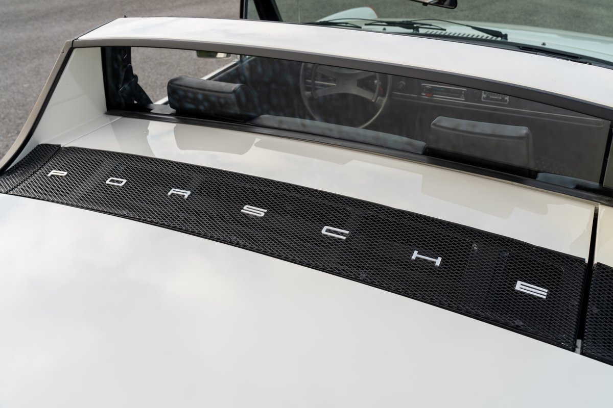White 1974 Porsche 914 Can-Am with black mesh trim and "PORSCHE" lettering.
