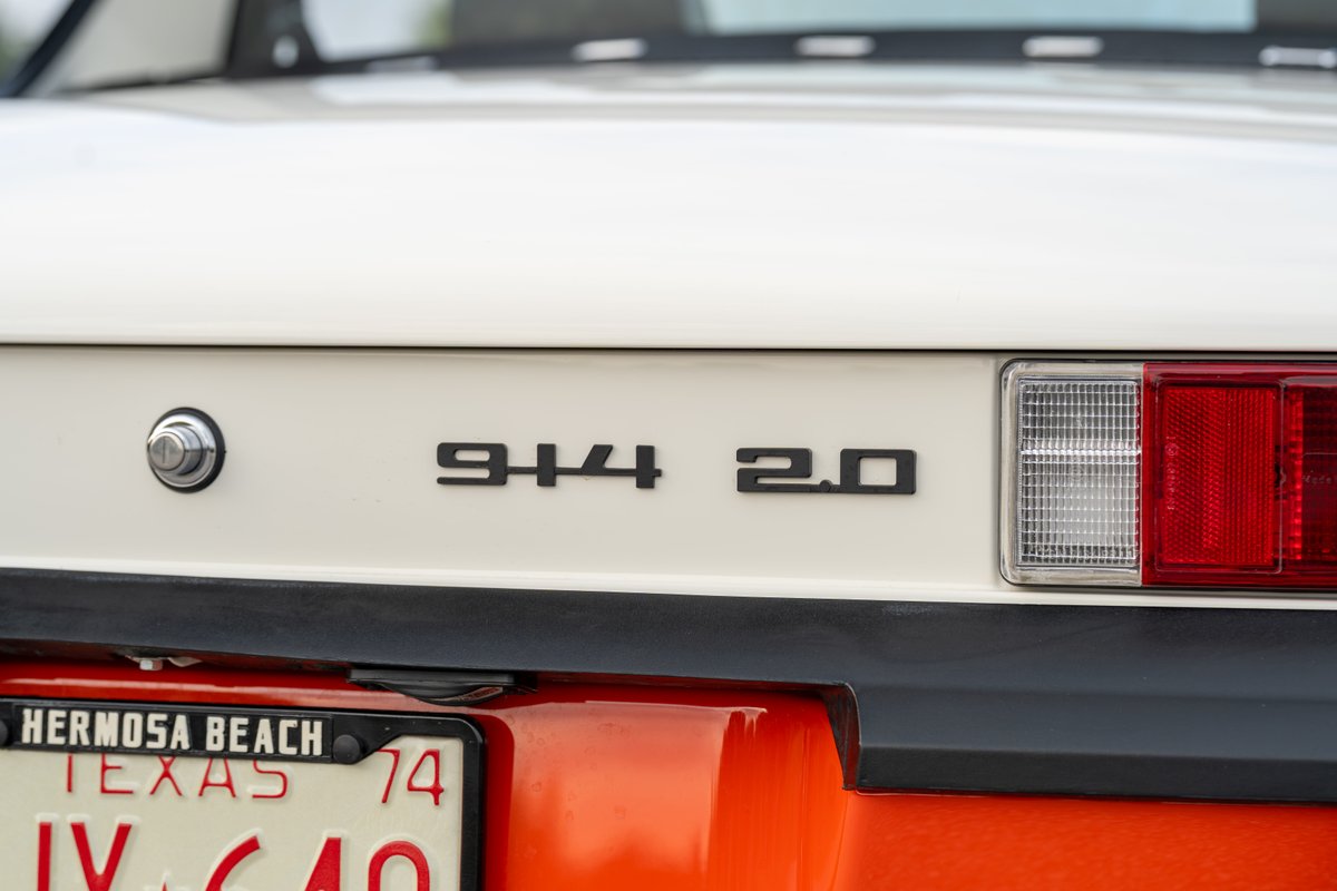 1974 Porsche 914 2.0 badge on a white rear panel with black trim.