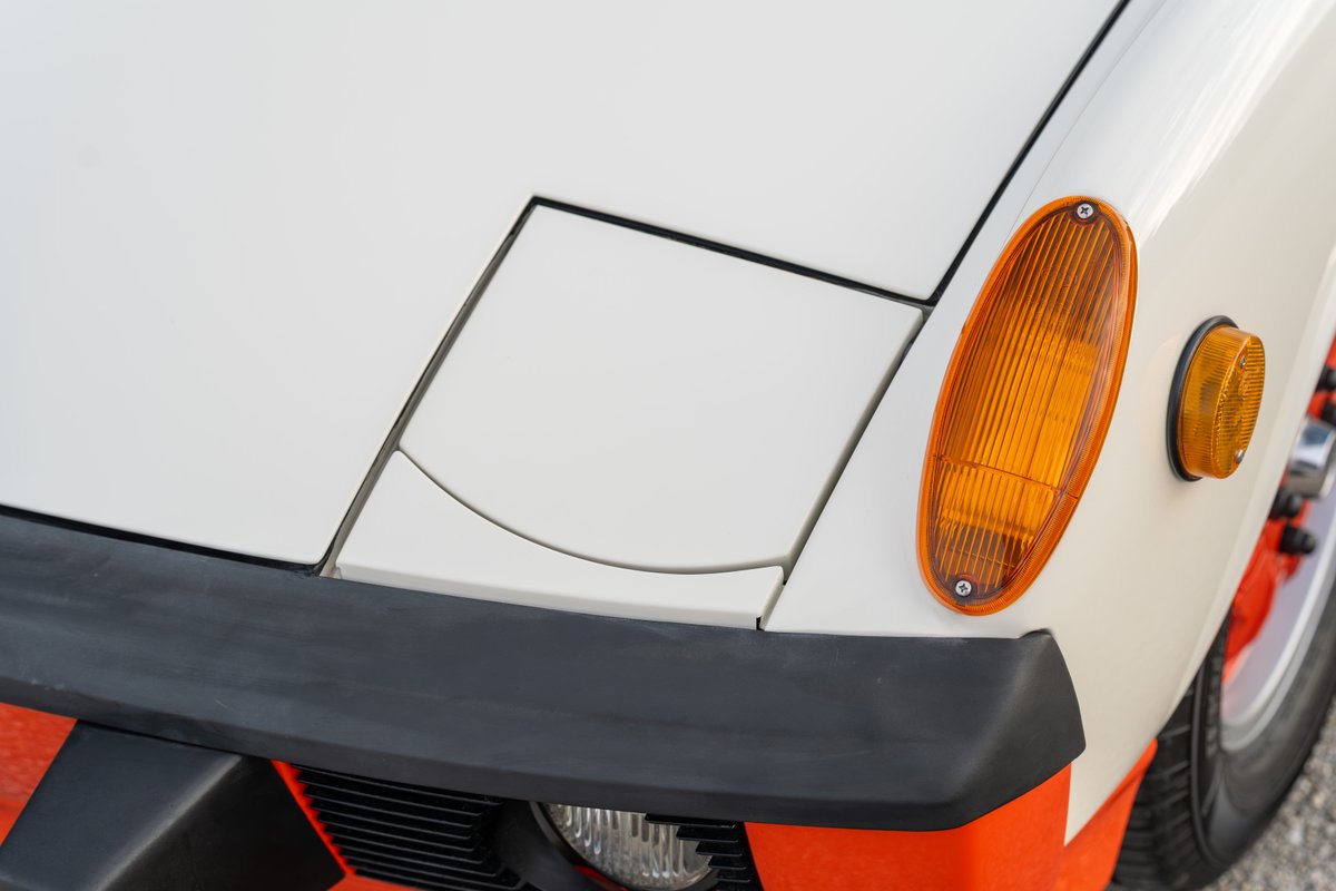 1974 Porsche 914 Can-Am with orange trim and clear headlight.