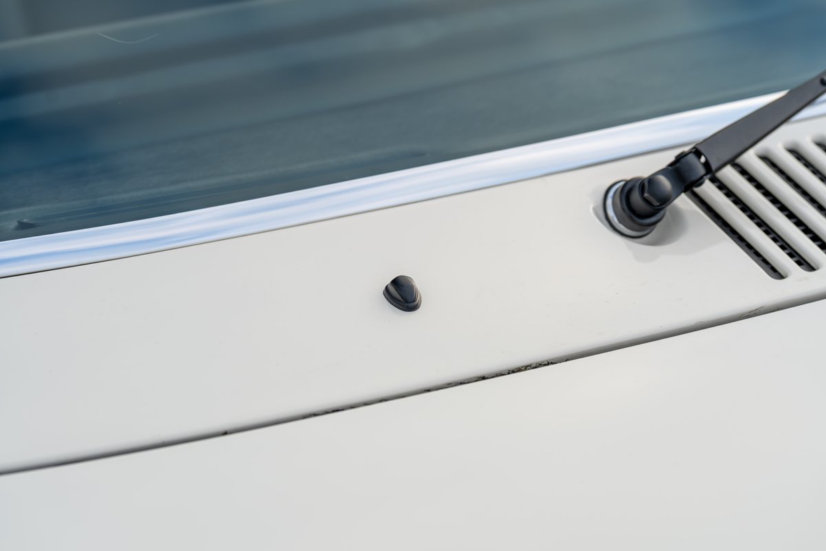 Detail of a cream 1974 Porsche 914 Can-Am with wiper assembly and dash vent.