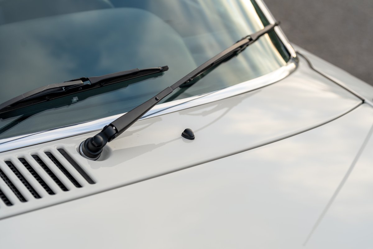 1974 Porsche 914 Can-Am in creamsicle white, detail of windshield wipers and vent.