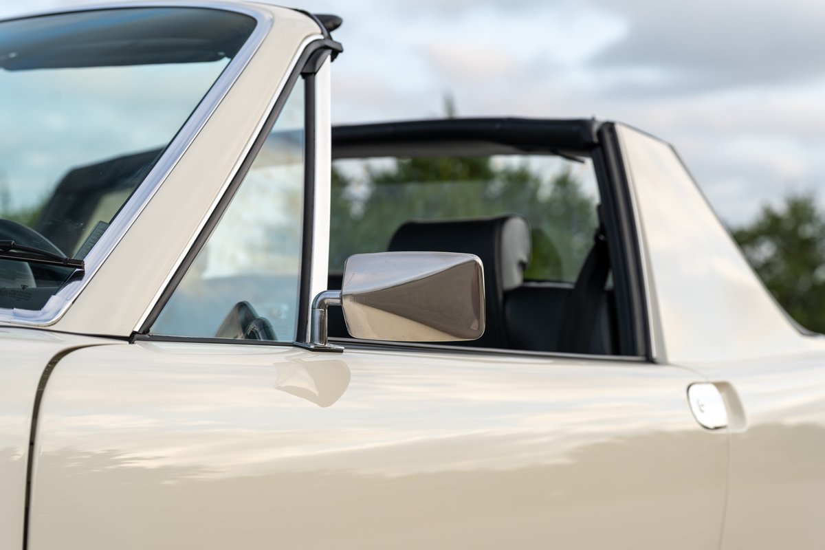 Close up of the driver's side of a cream 1974 Porsche 914 Can-Am LE convertible.