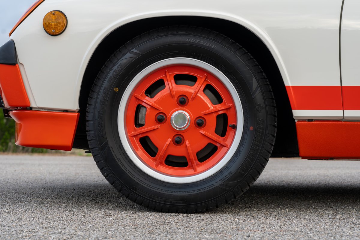 1974 Porsche 914 Can-Am LE with orange rims, white body, and red stripe livery.
