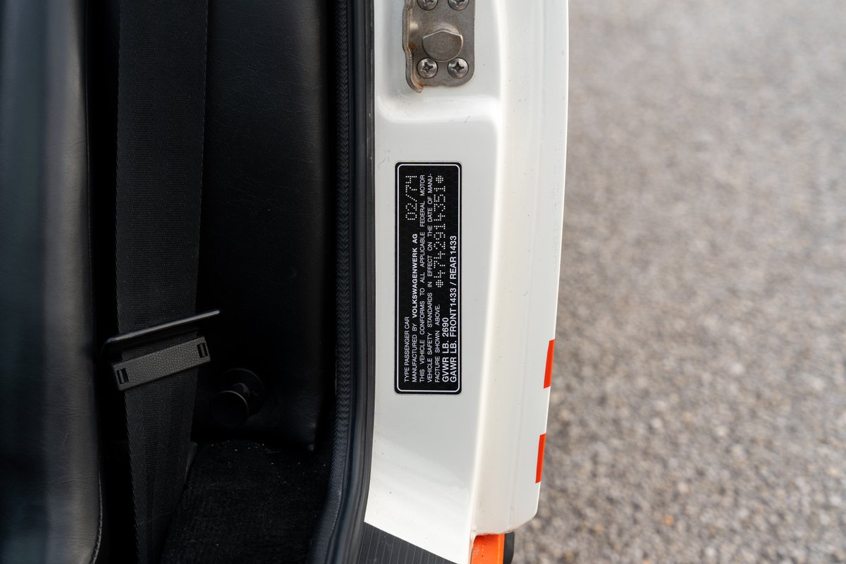 Close-up of a 1974 Porsche 914 Can-Am LE door jamb sticker with VIN and weight info.