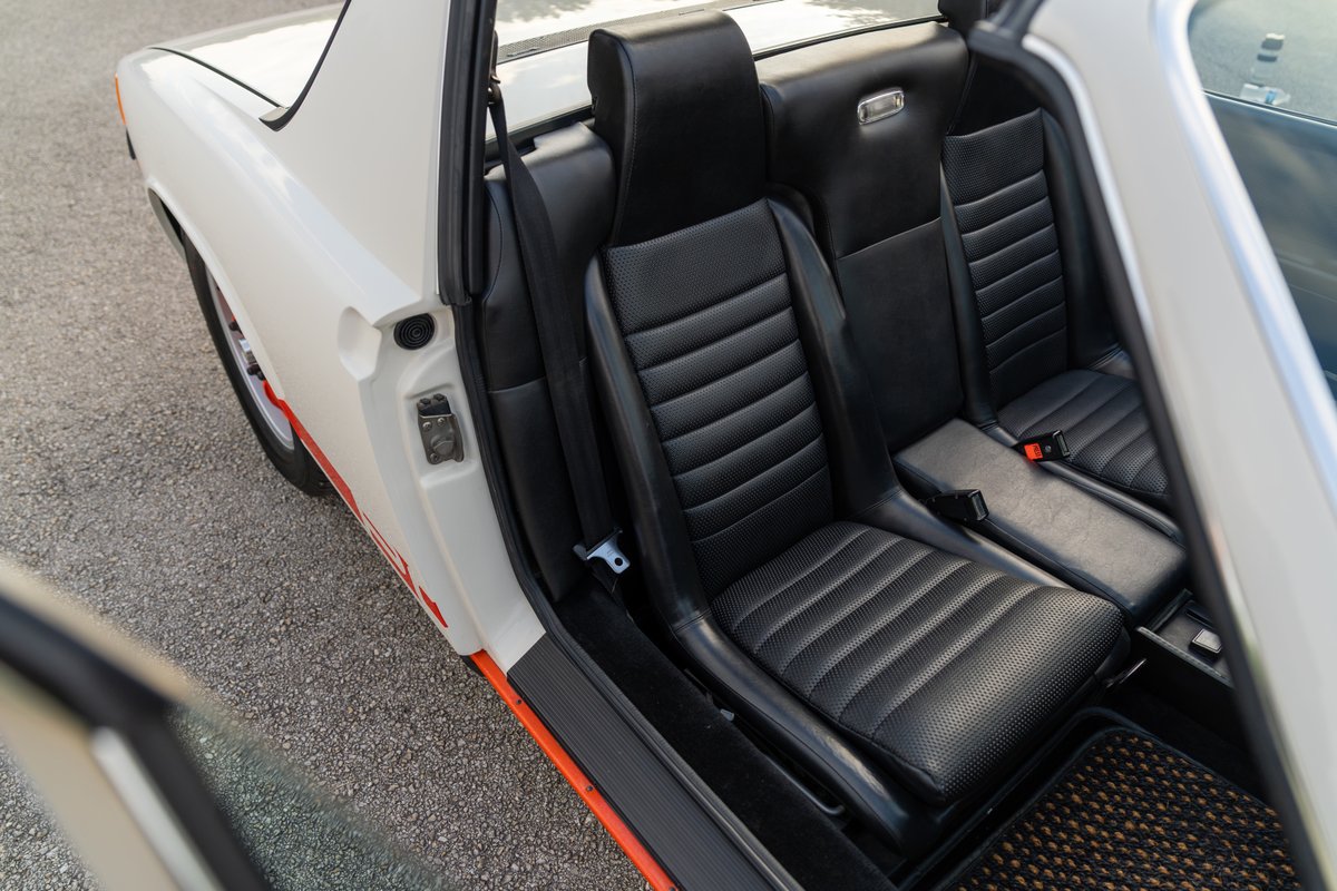 1974 Porsche 914 Can-Am LE interior with black ribbed seats and orange trim.