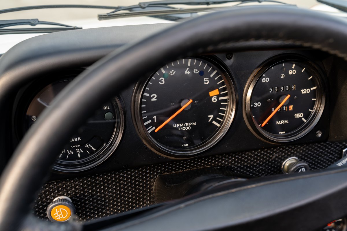 Close-up of 1974 Porsche 914 Can-Am LE dashboard with three gauges: fuel, tachometer, and speedometer.