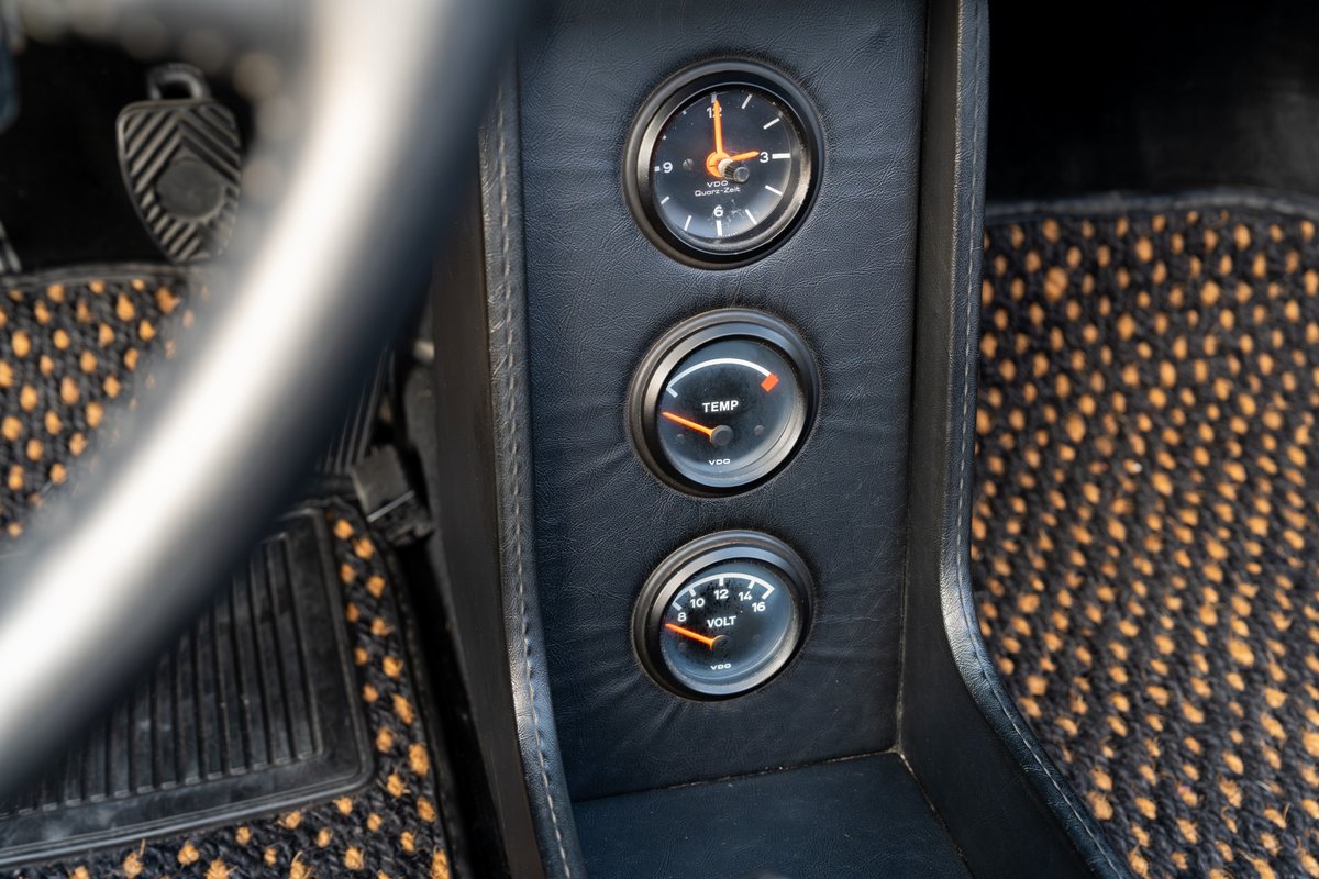 1974 Porsche 914 Can-Am gauge cluster with clock, temperature, and voltage meters.