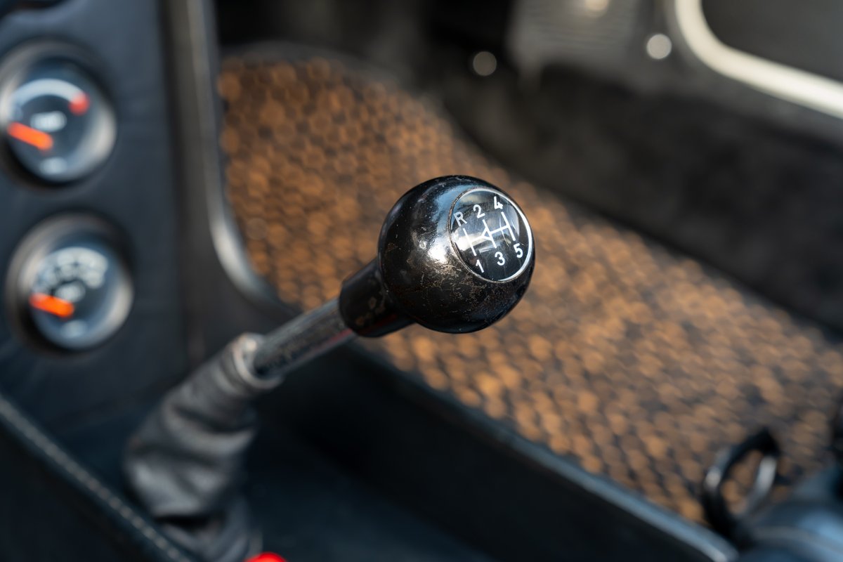 Close up of a 1974 Porsche 914's 5-speed manual shifter and dash gauges.