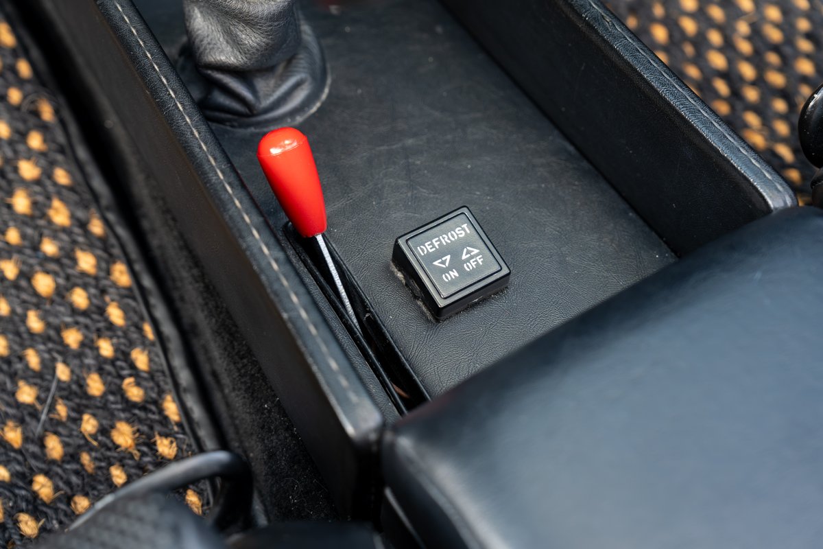 1974 Porsche 914 center console with red shift knob and defrost switch.