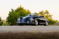 Black Intermeccanica Porsche 356 Speedster with chrome trim and rims.
