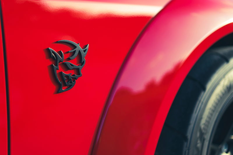 Redline Red Dodge Challenger SRT Demon widebody fender with iconic matte black Demon badge.