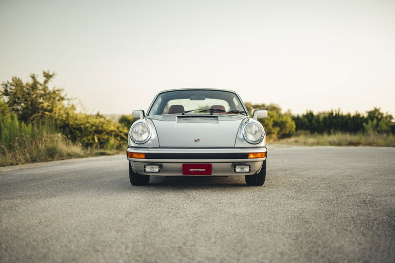 Silver metallic 1977 Porsche 911S front fascia. Iconic headlights, rubber-padded bumper with integrated fog lights.