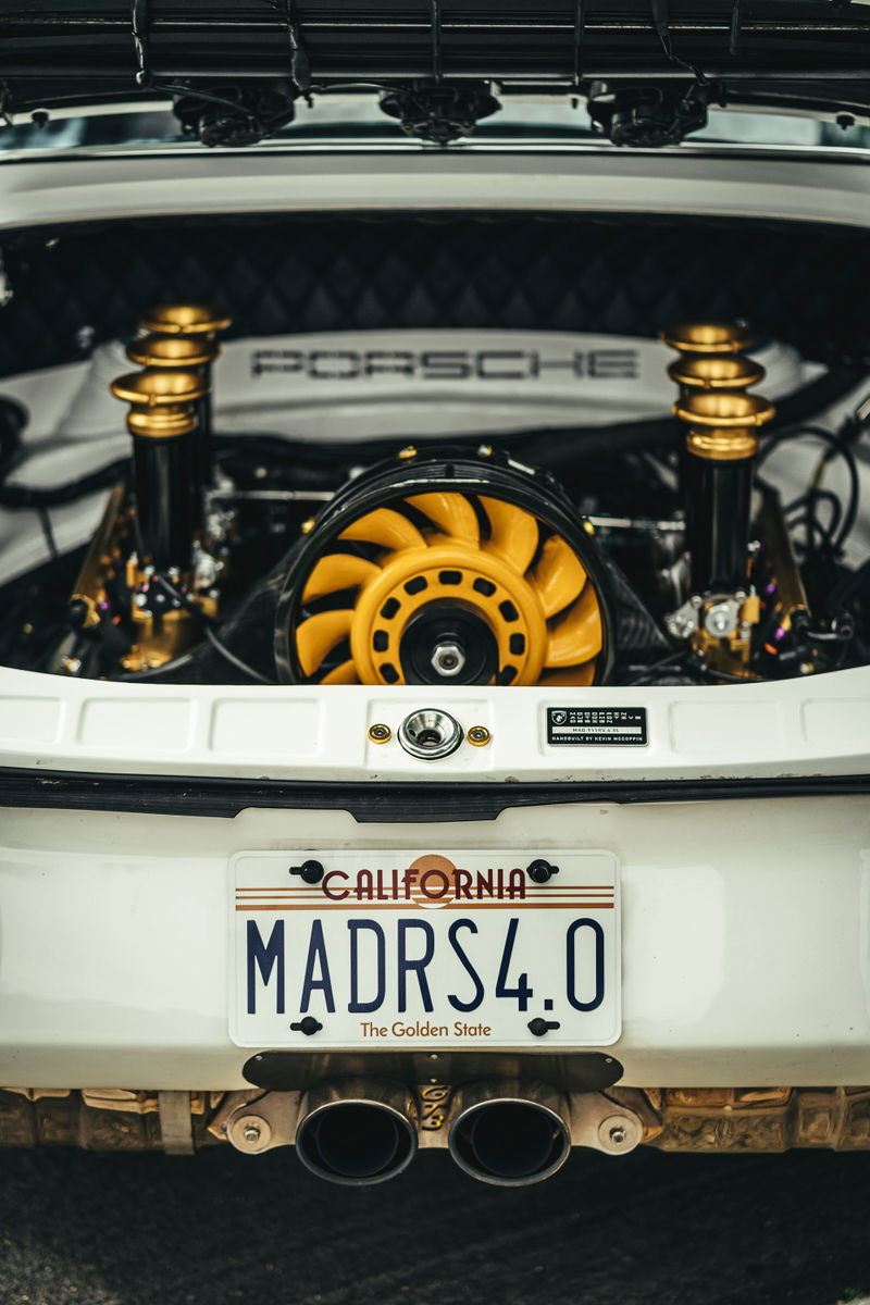 White Porsche 911 GT3 RS 4.0 rear, with exposed custom air-cooled flat-six engine bay, yellow fan, and gold coilovers.