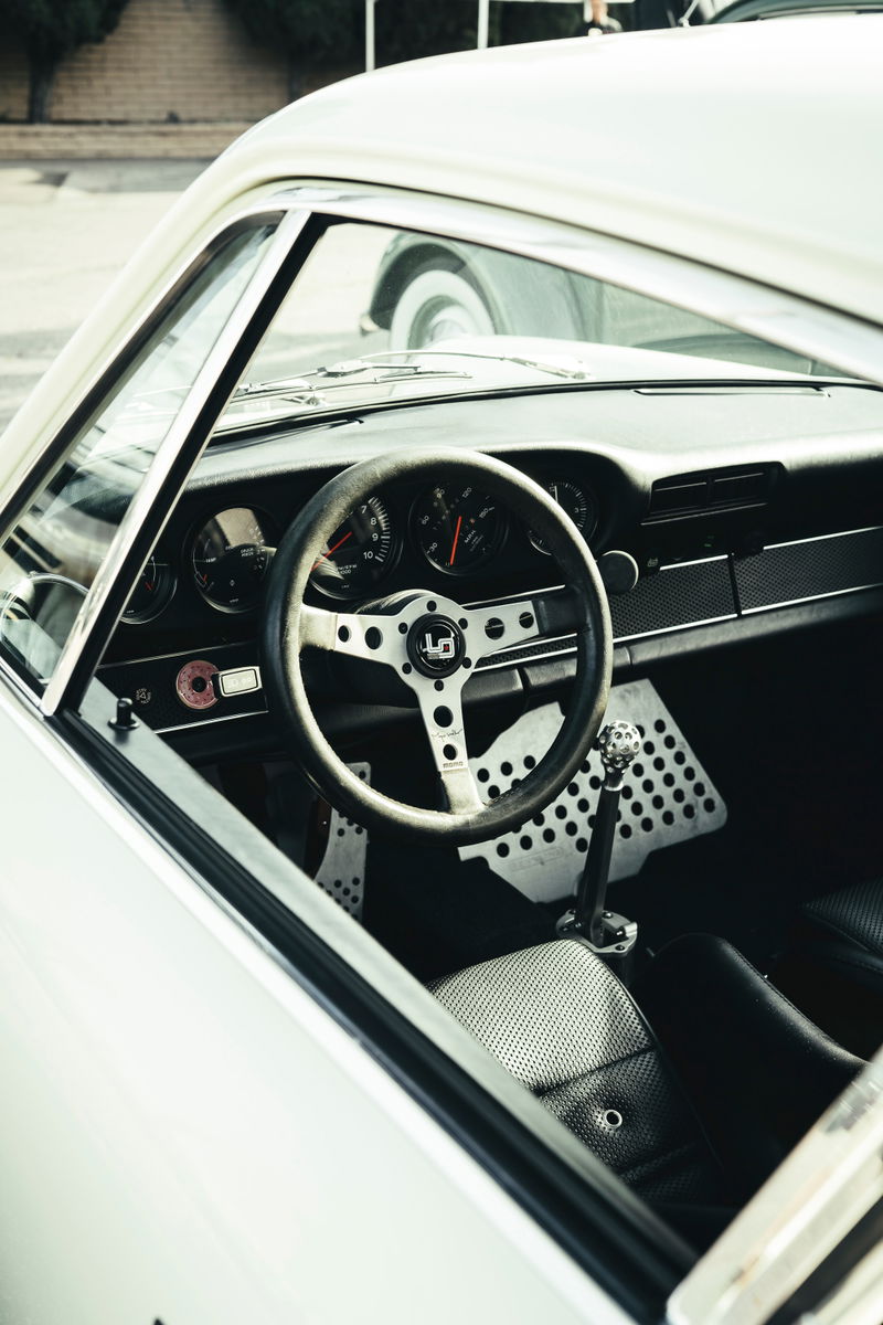 Classic white air-cooled Porsche 911 interior. 3-spoke performance steering wheel, drilled pedal box, short shifter, perforated seats.