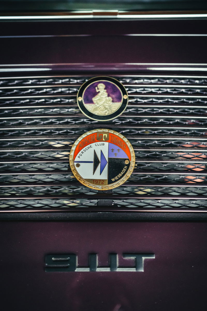 Dark metallic purple Porsche 911T rear grille, featuring vintage Porsche Club Wiesbaden 1972 and cherub badges.