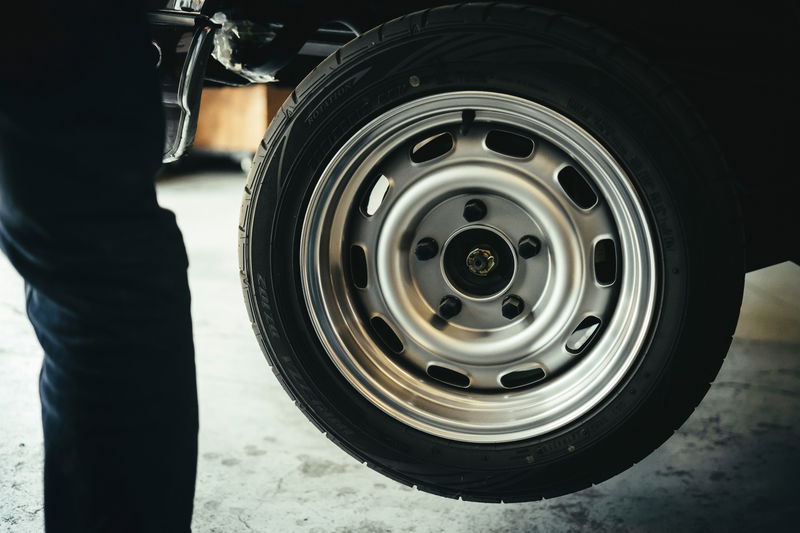 Classic JDM car's silver multi-hole steelie-style rims, polished lip, and performance tire at Lit Show LA.