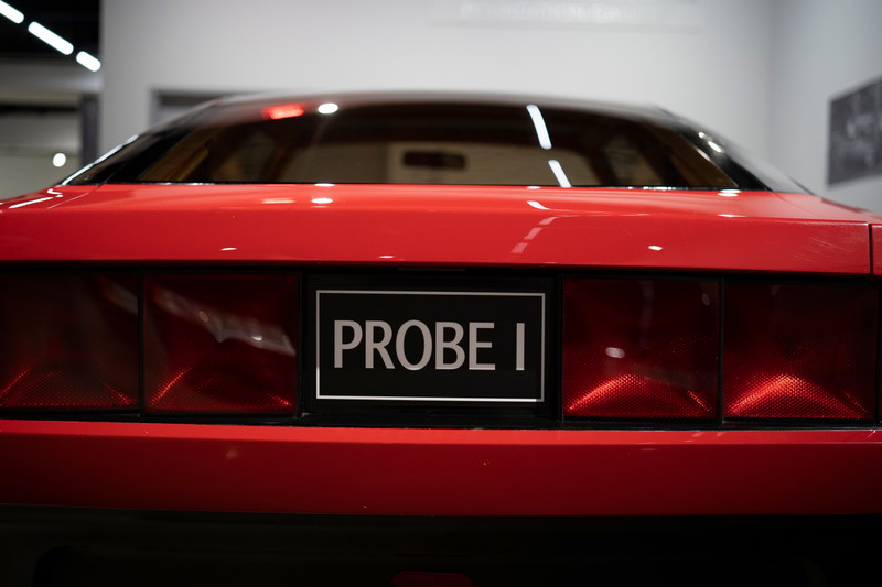 Rear view of the red Ford Probe I concept car, highlighting its wide taillight design and "PROBE I" badging.