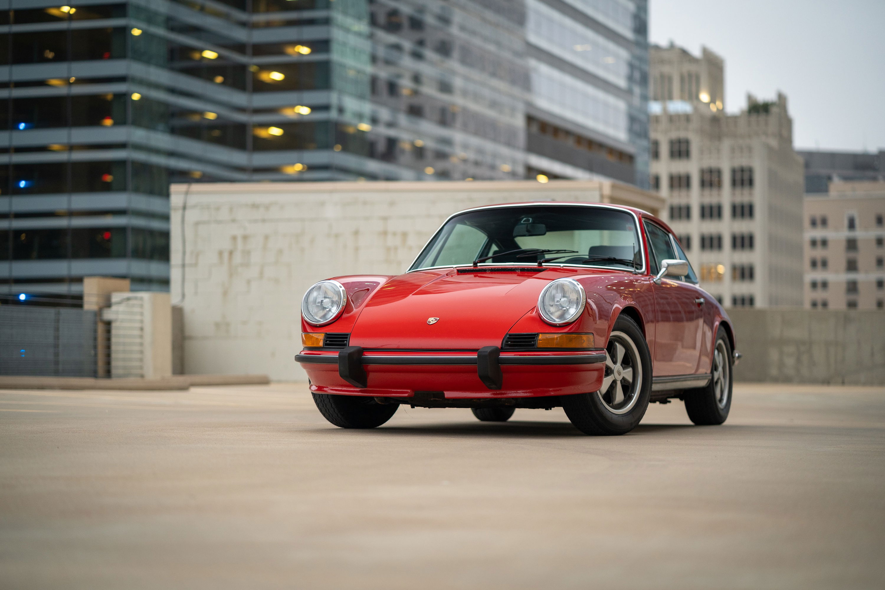 1973 Porsche 911S in Bahia Red with chrome trim and Fuchs wheels.