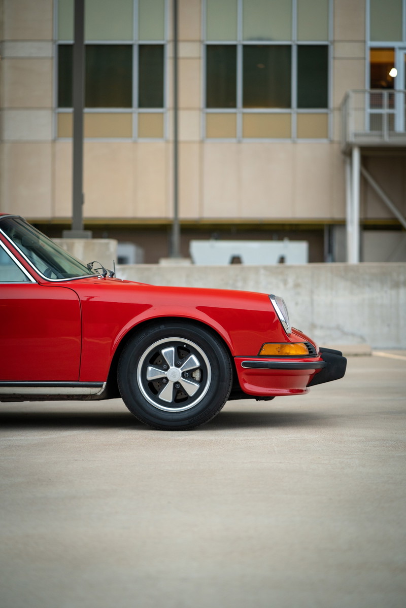 1973 Porsche 911S in Bahia Red, front quarter view, showing Fuchs rims and chrome trim.