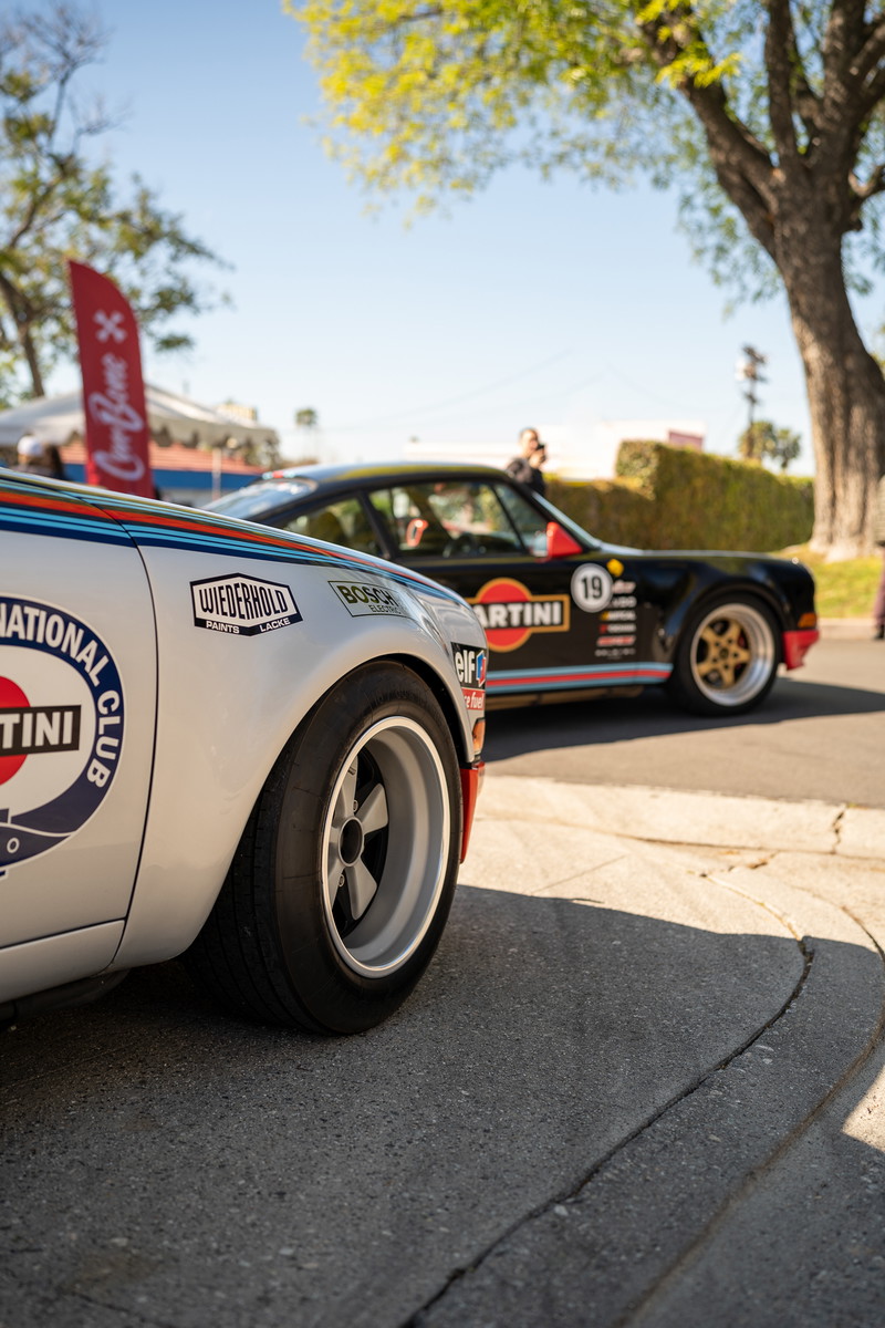 Silver Porsche 911 with Martini livery and classic Fuchs rims.