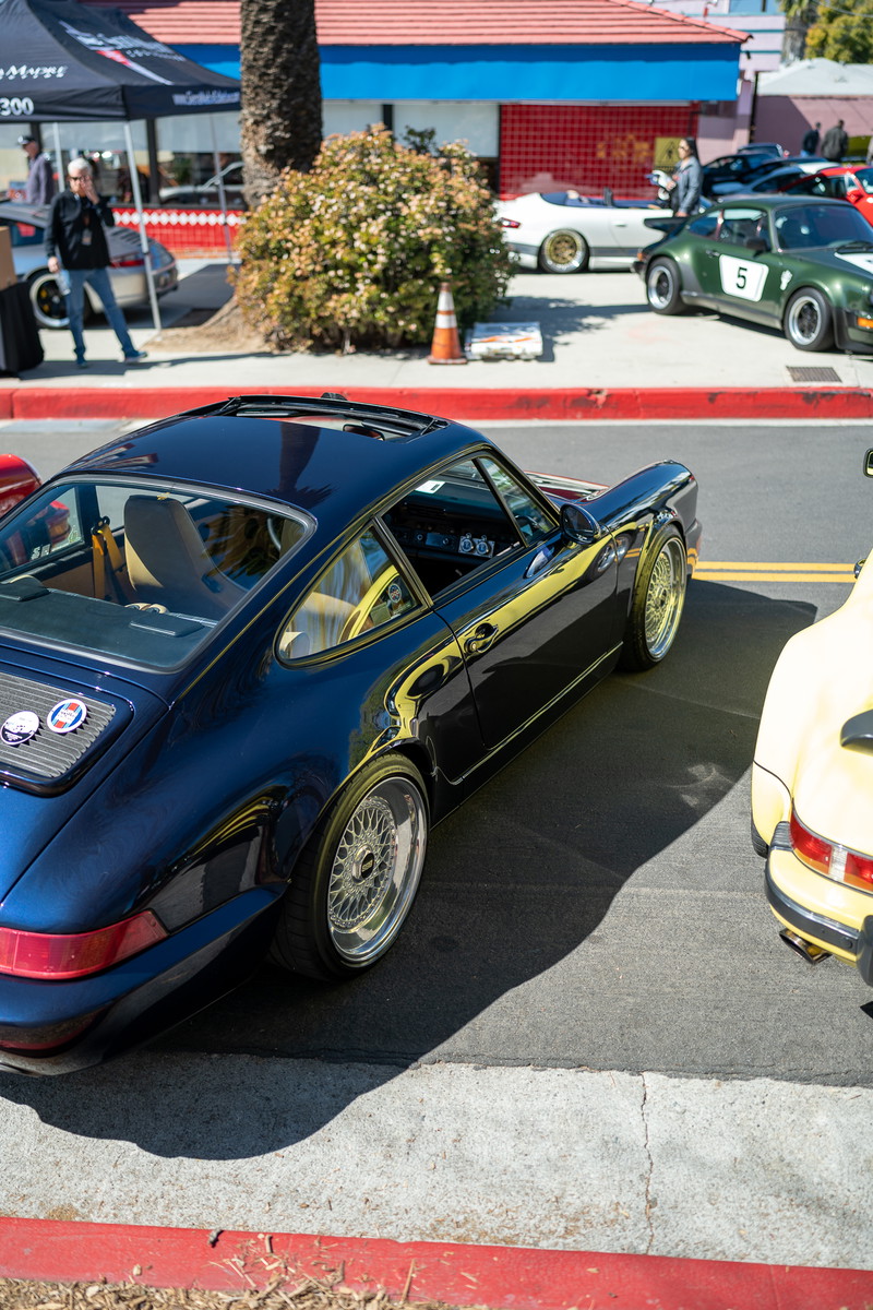 1973 Porsche 911 Carrera RS Targa in dark blue with BBS rims and yellow trim.