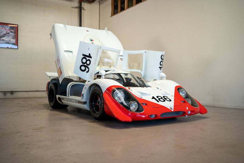 Vintage Porsche 917K race car, white with red accents and "186" livery.
