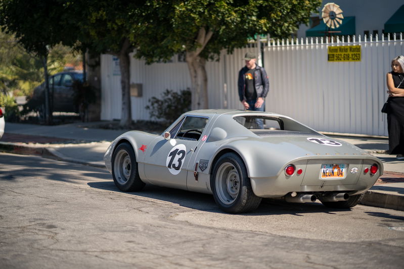 Silver 1966 Porsche 906 with racing livery and #13 on the rear.