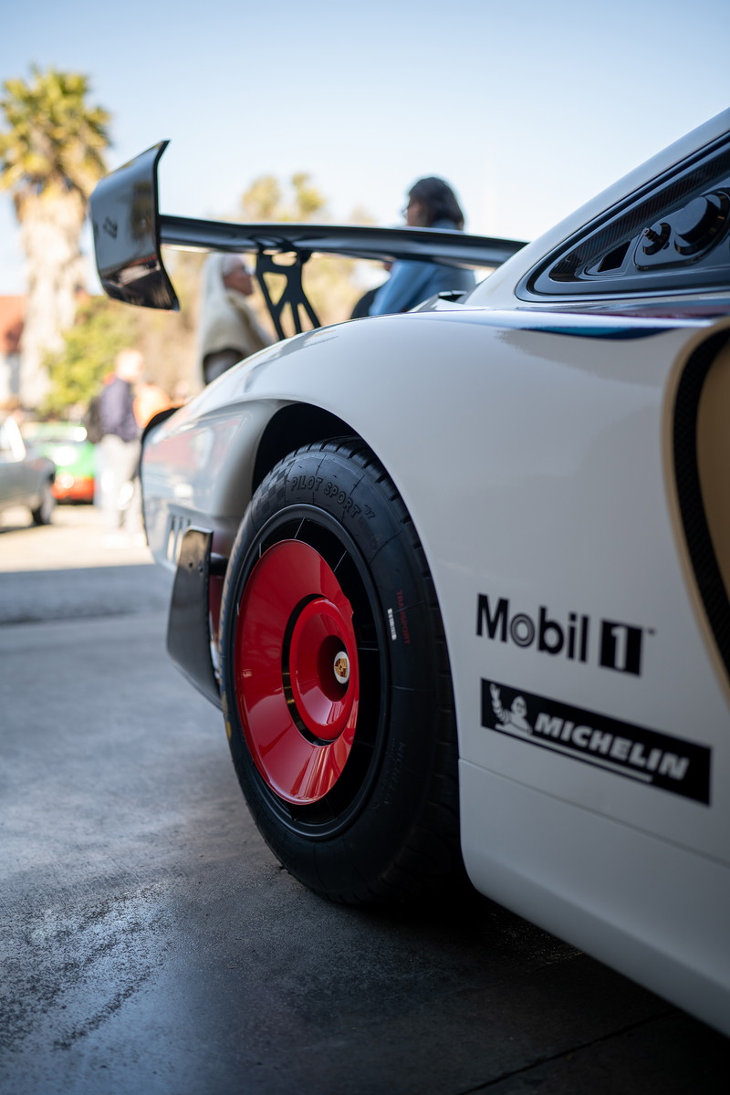 White Porsche 935 with red center-lock rims, Mobil 1 & Michelin livery.
