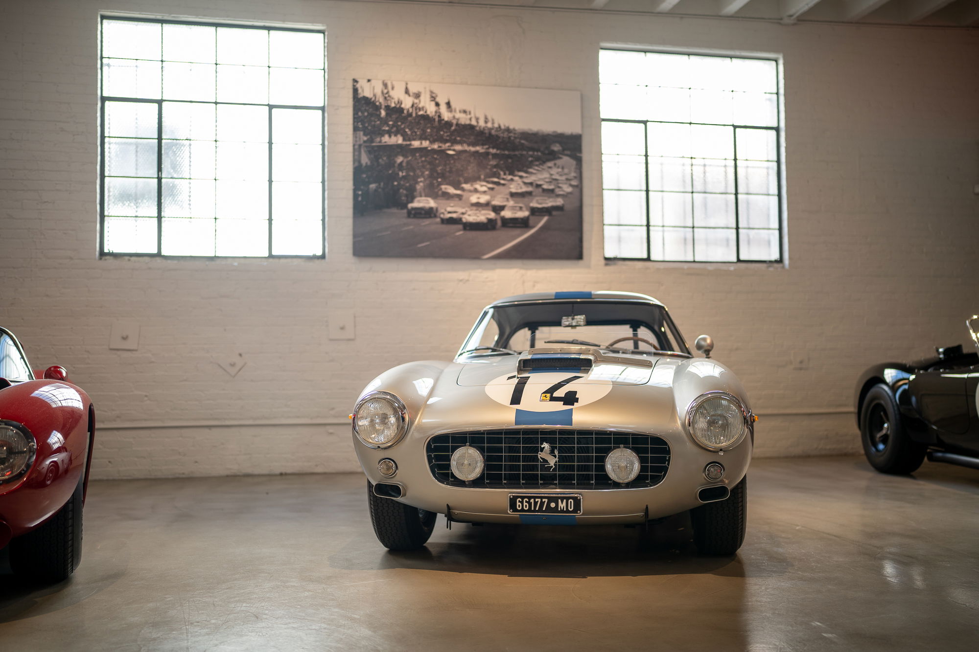 Silver Ferrari 250 GT Berlinetta "Tour de France" with racing livery and blue stripes.