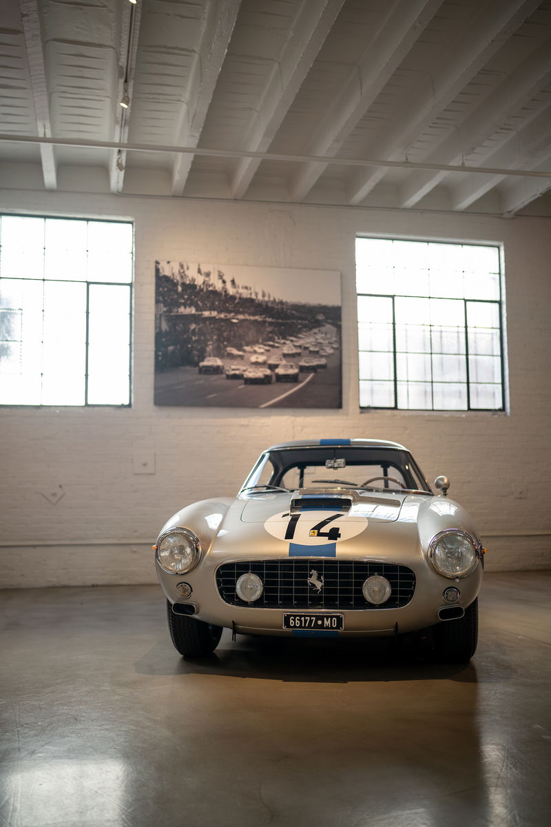 Silver Ferrari 250 GT Berlinetta with racing livery number "14" on hood.