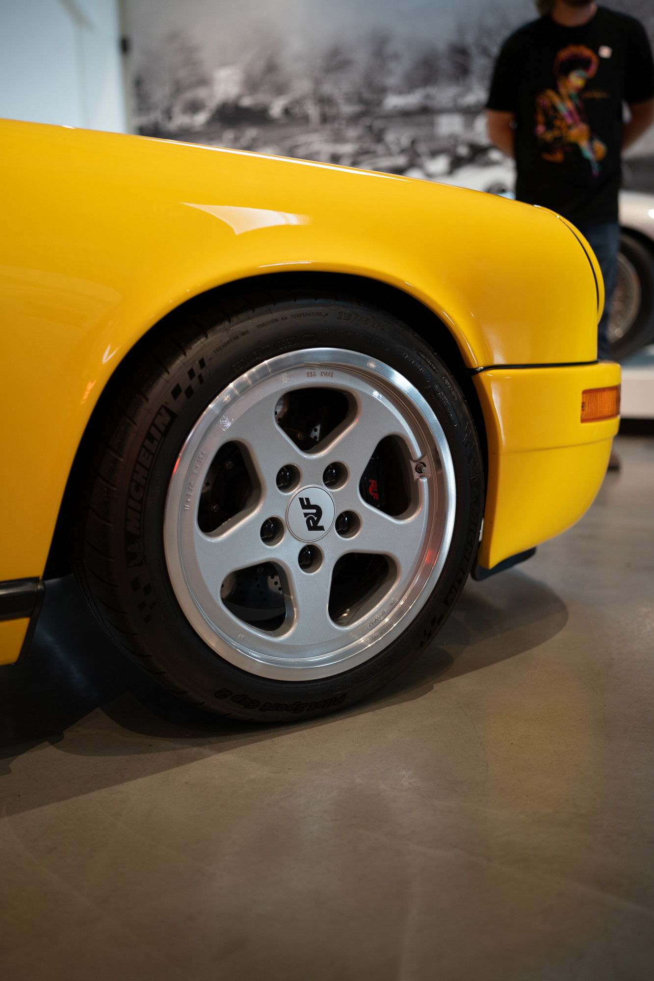 Yellow Porsche 911 with RUF five-spoke alloy rims and black brake calipers.