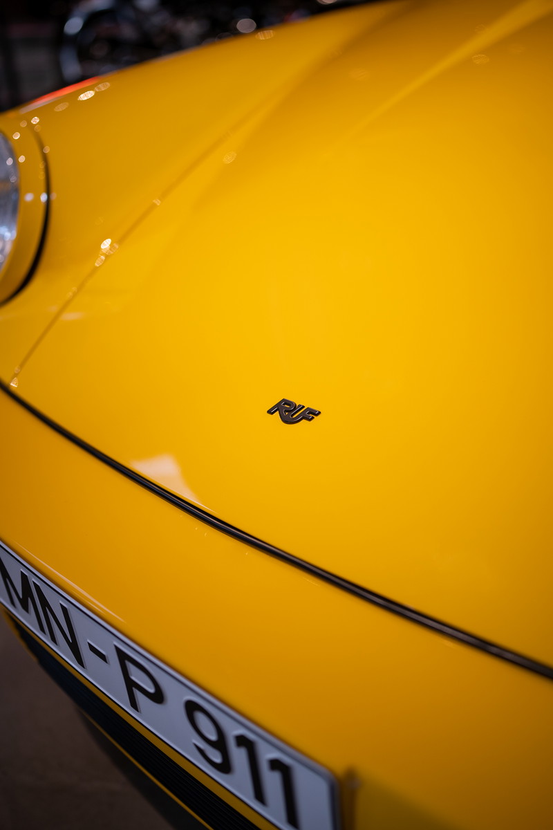 Yellow RUF 911 with black trim detail and badging.
