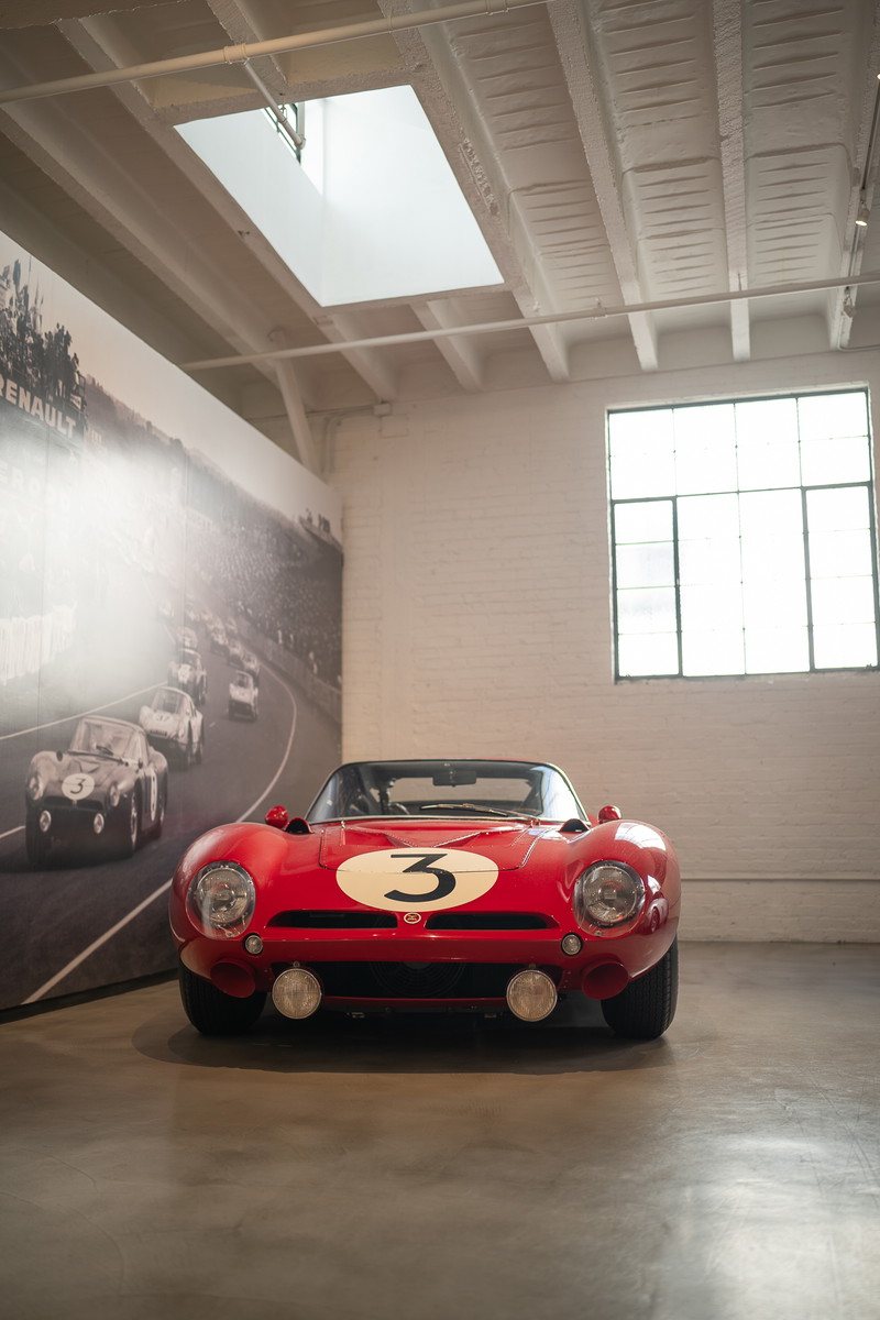 Classic red race car with white roundel and number "3" livery, prominent headlights, and chrome trim.