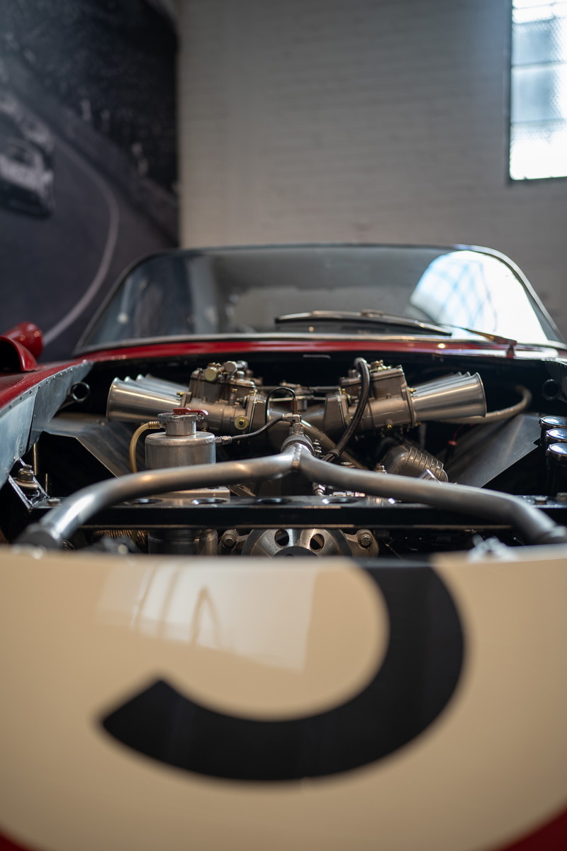 Classic red & cream race car with exposed dual carburetors and racing number 3 livery.