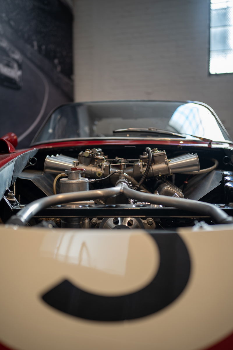 Classic red & cream race car with exposed dual carburetors and racing number 3 livery.