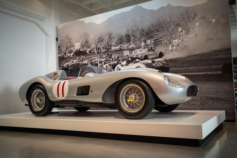 1950s Ferrari 500 TRC race car with iconic red and white racing livery and wire-spoke rims.