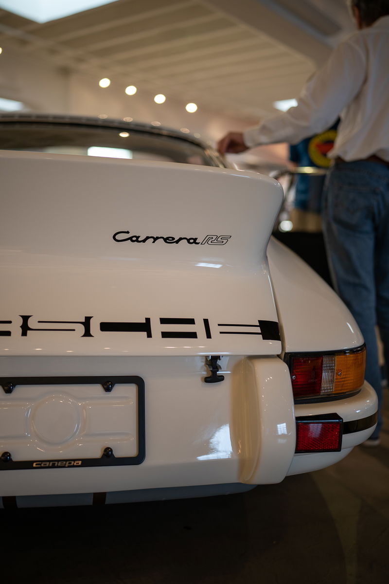 White Porsche Carrera RS with black livery and trim.