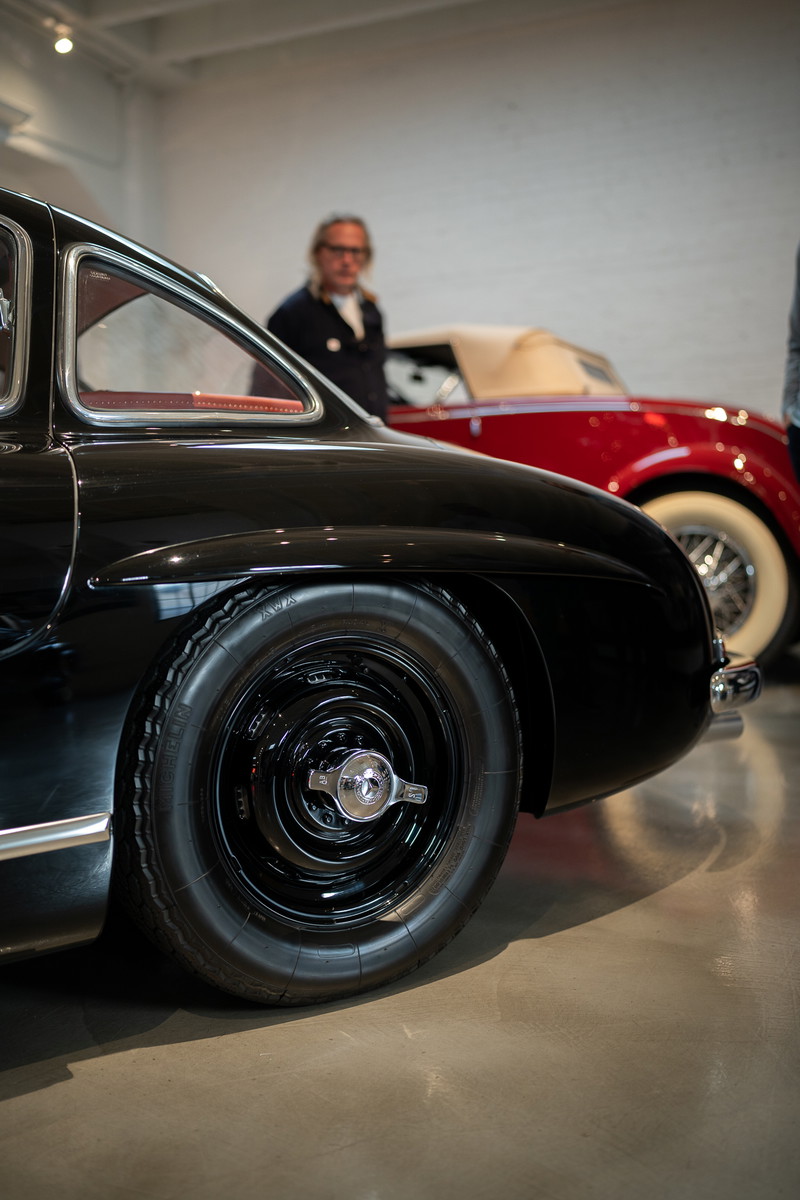Close-up of a black 1950s Mercedes-Benz 300 SL Coupe wheel and fender.