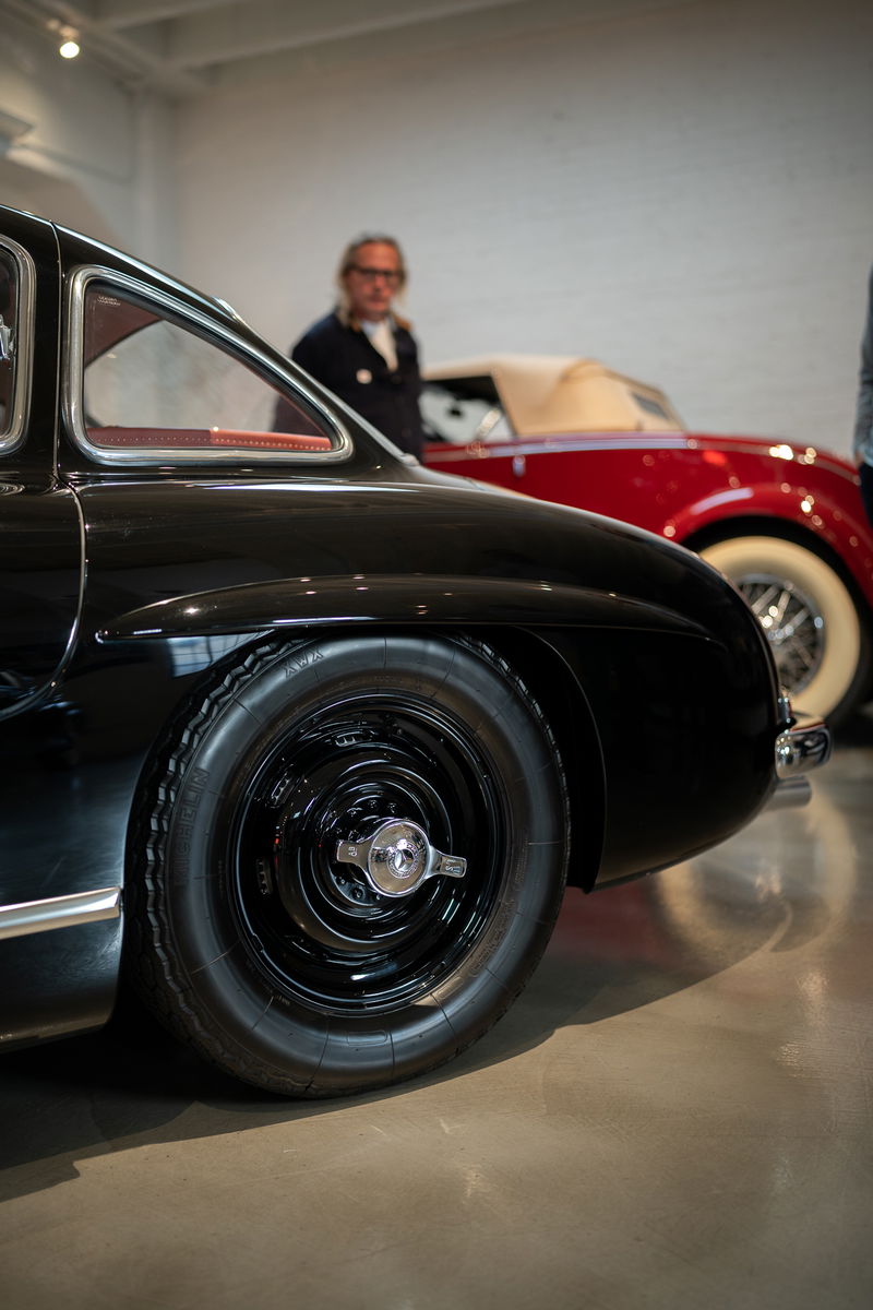 Close-up of a black 1950s Mercedes-Benz 300 SL Coupe wheel and fender.