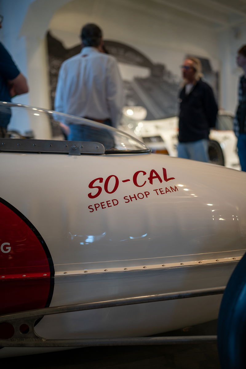 White vintage race car with red "SO-CAL SPEED SHOP TEAM" livery and a clear bubble canopy.