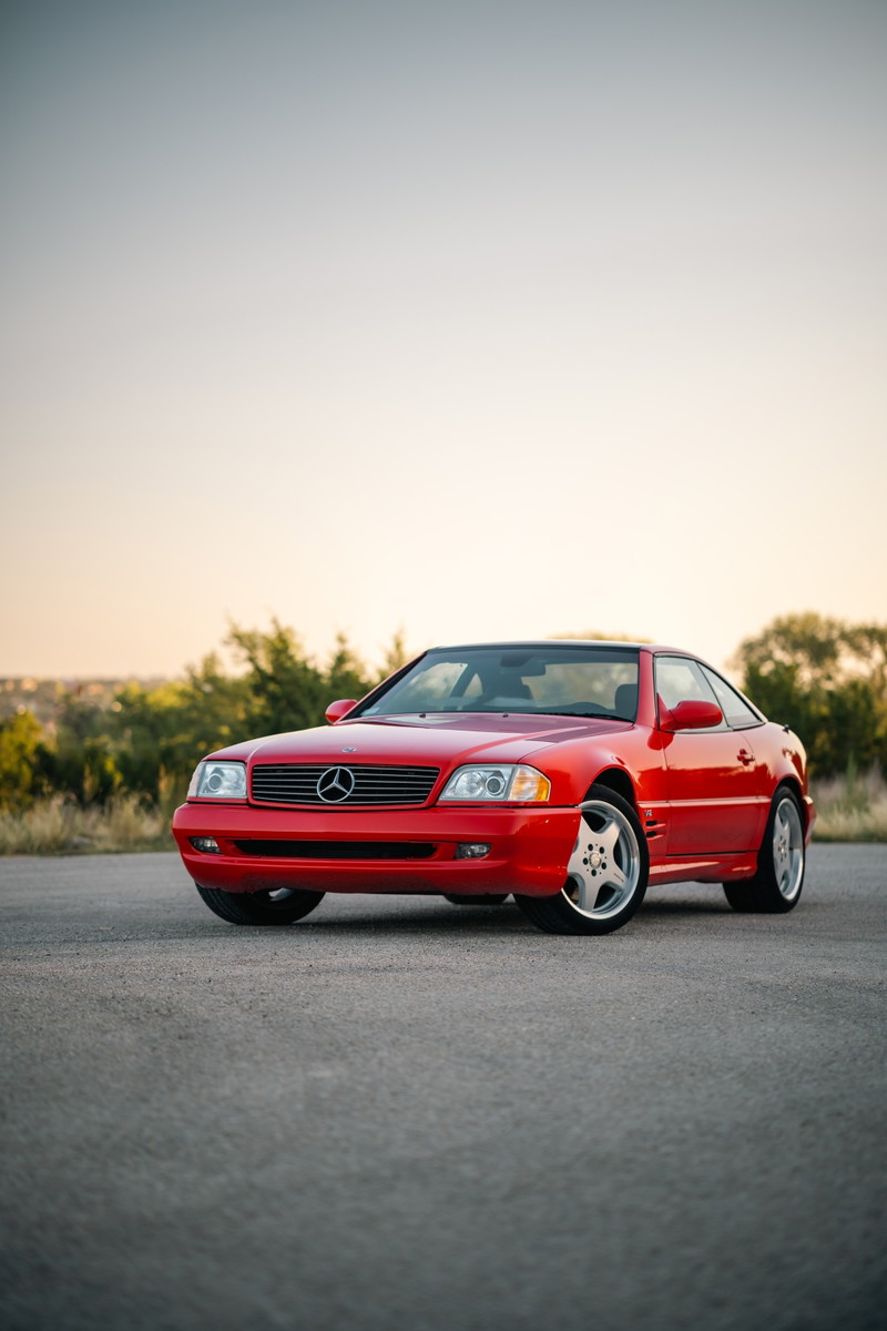 Red 2001 Mercedes-Benz SL600 with five-spoke alloy rims and chrome trim.
