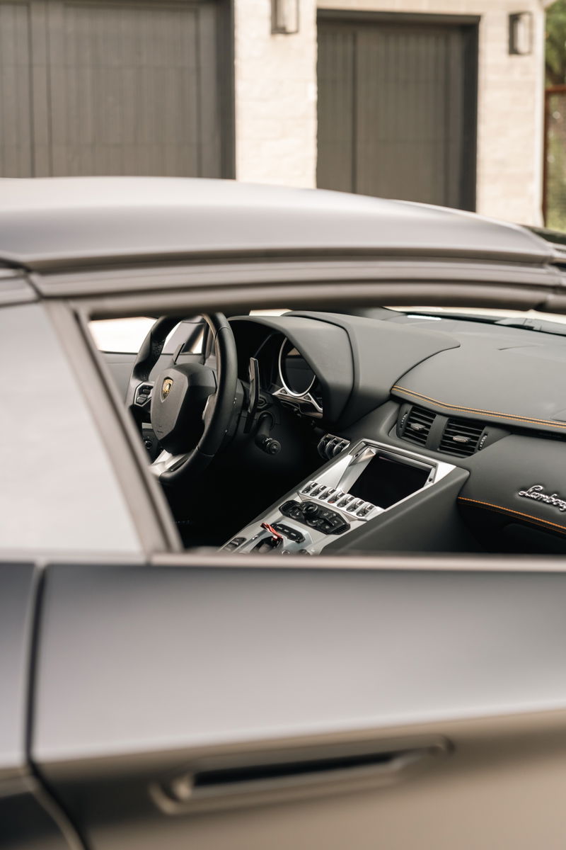 Lamborghini Aventador LP700-4 interior, showing sport seats, digital dash, and center console.