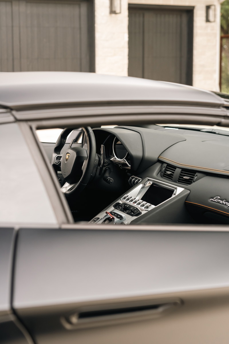 Lamborghini Aventador LP700-4 interior, showing sport seats, digital dash, and center console.