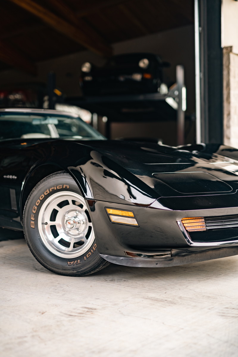 A black 1982 Chevrolet Corvette Stingray with polished alloy rims and BFGoodrich tires.
