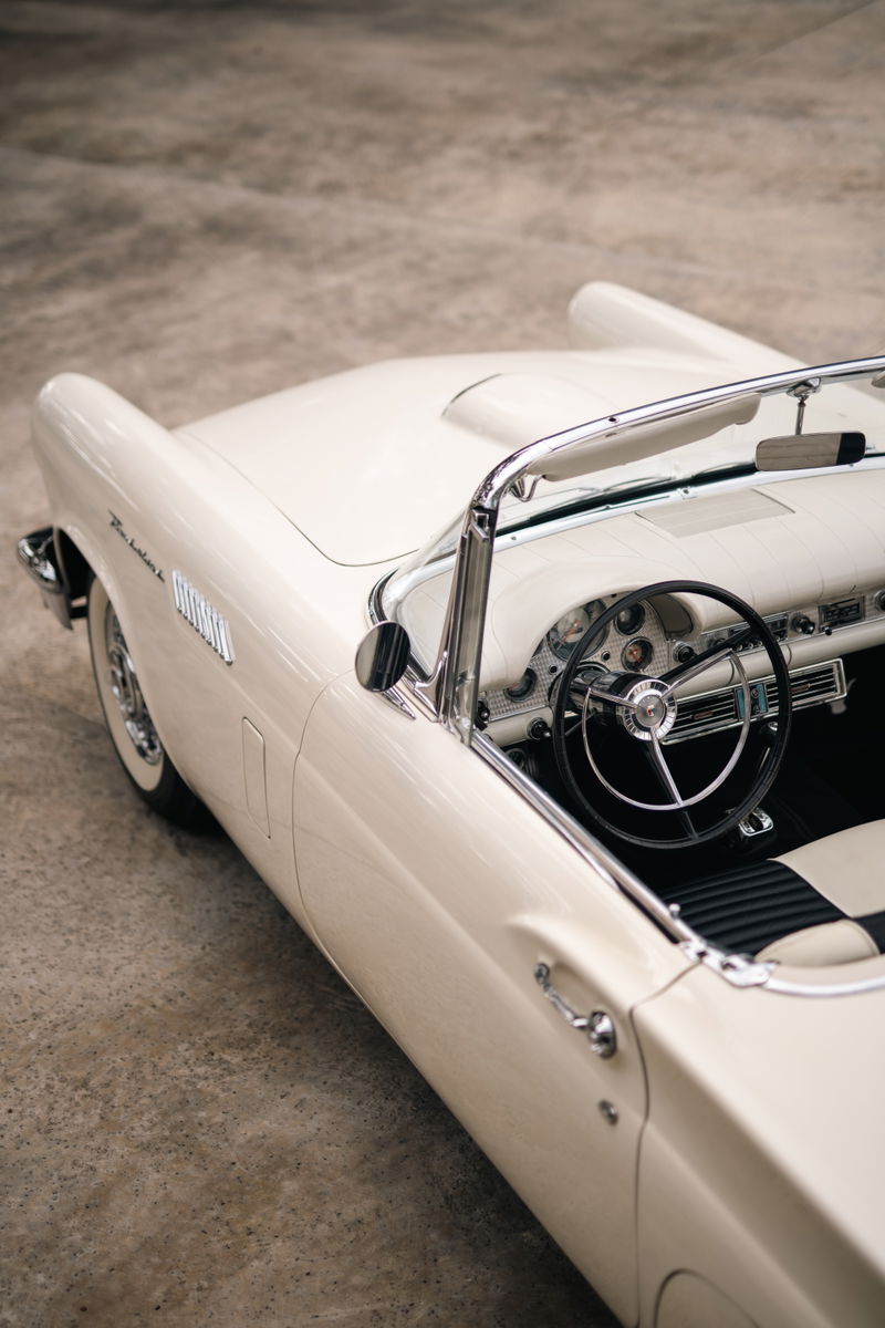 1957 Ford Thunderbird convertible in Colonial White. Close-up on interior and side body panel.
