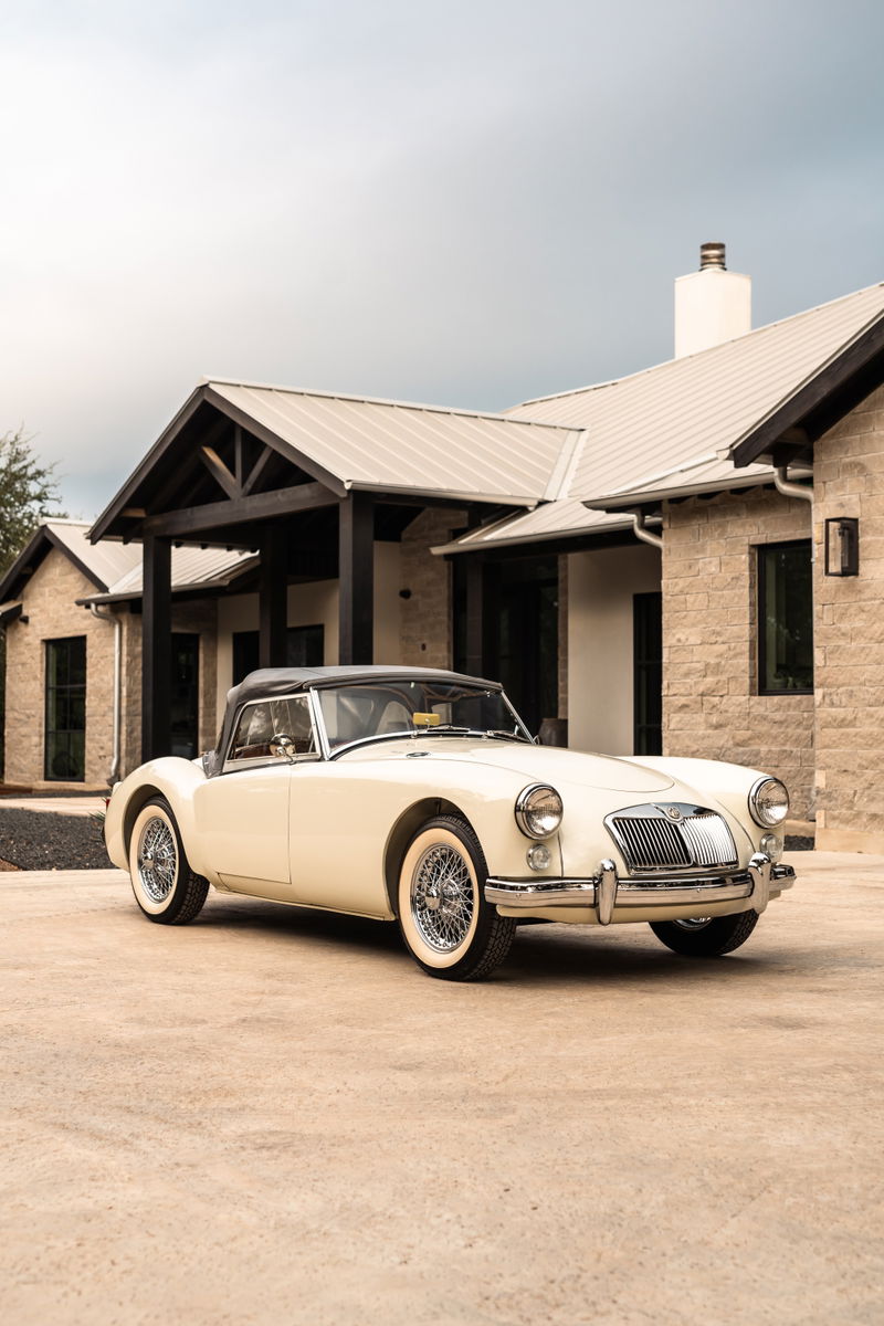 Old English White 1957 MG A convertible with wire wheels and chrome trim.