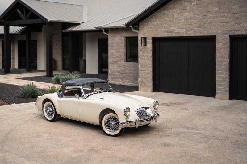 1957 MG MGA Roadster in Old English White with chrome wire rims and whitewall tires.