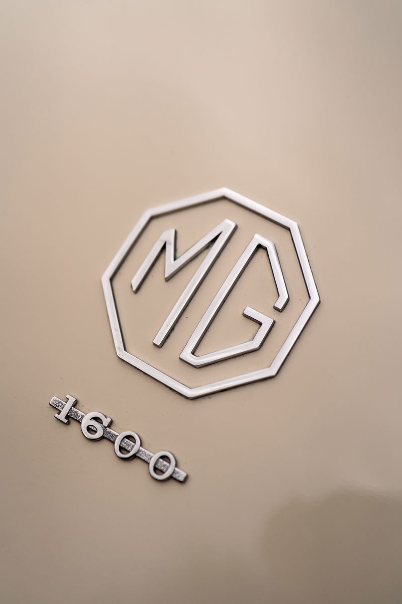 Chrome "MG" badge and "1600" trim on the Old English White 1957 MG MGA.
