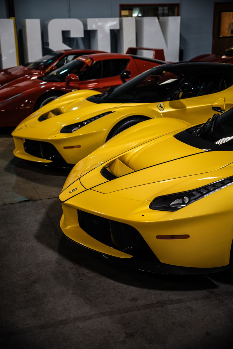 Yellow Ferrari LaFerrari, Giallo Modena, black trim and roof, on concrete.